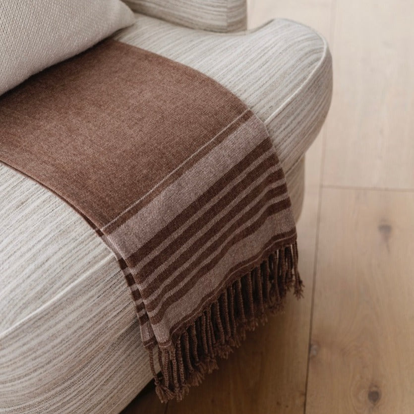 Brown chenille fringe blanket with elegant fringe, displayed on a chair - saranoni