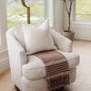 Soft brown chenille fringe blanket adding a touch of luxury to a chair - Saranoni