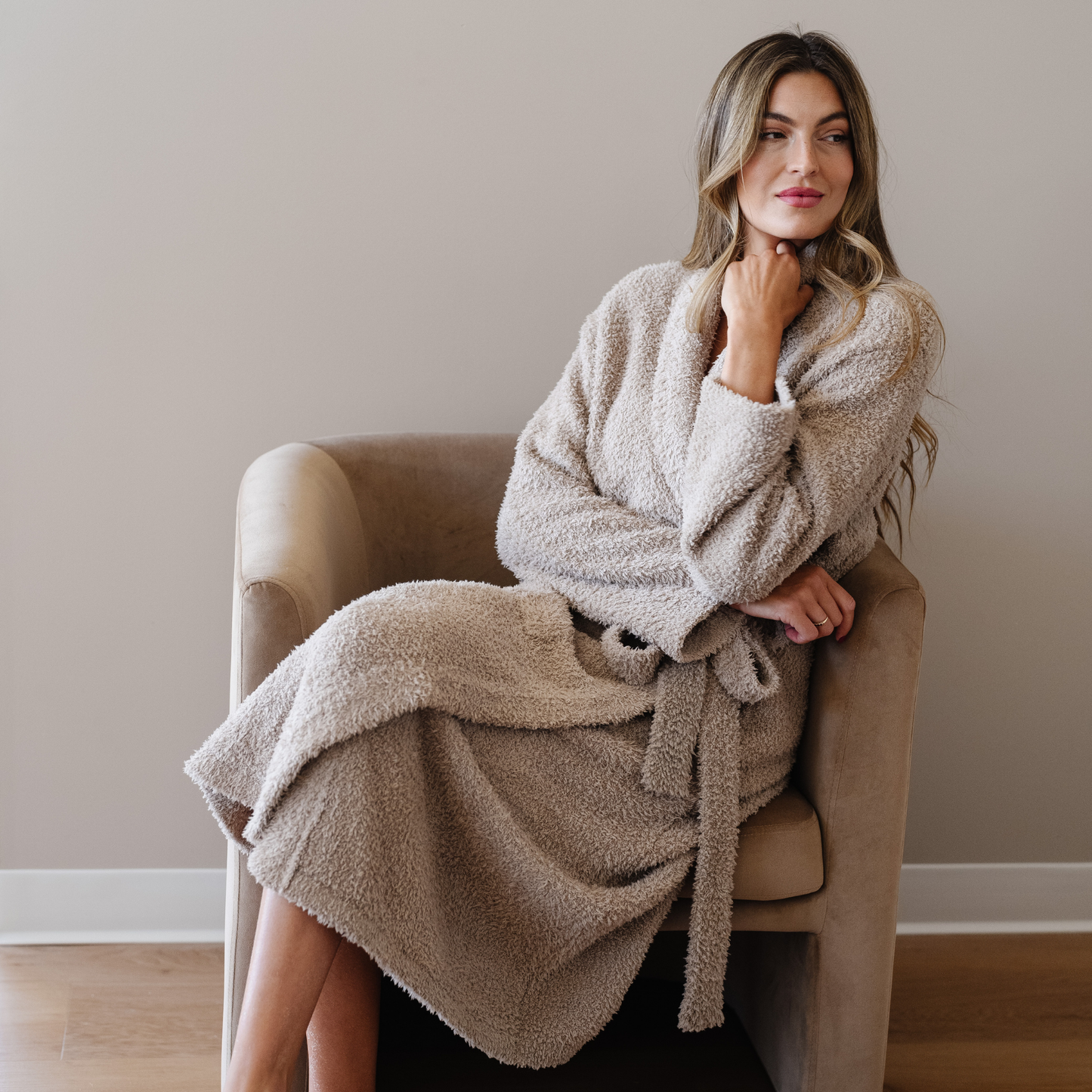 Woman wearing taupe bamboni robe sitting in chair. 