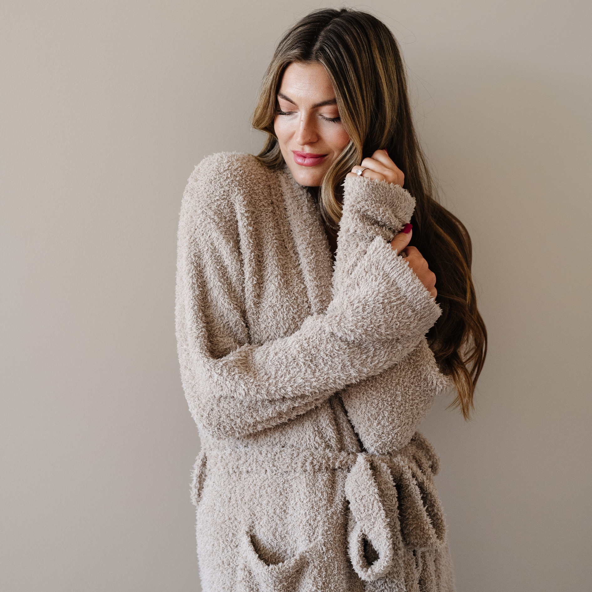 Woman wearing taupe cozy bamboni robe. 