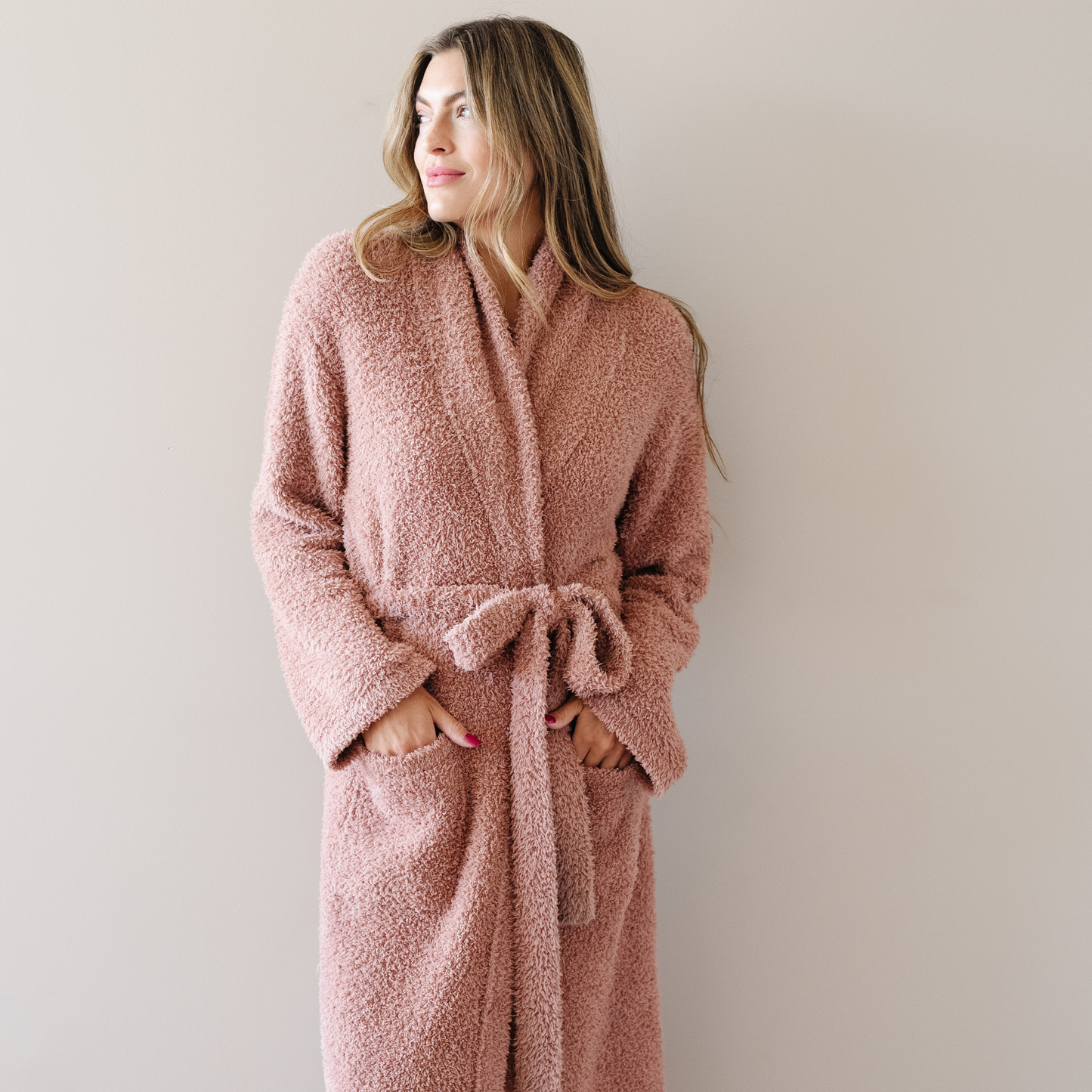 Woman wearing French Rose Bamboni cozy robe. 