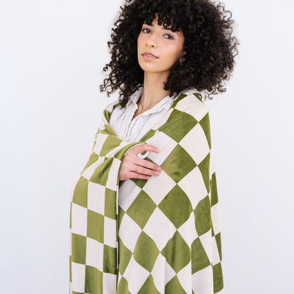 Woman wrapped in an Olive and Cream checkered minky stretch XL blanket. 