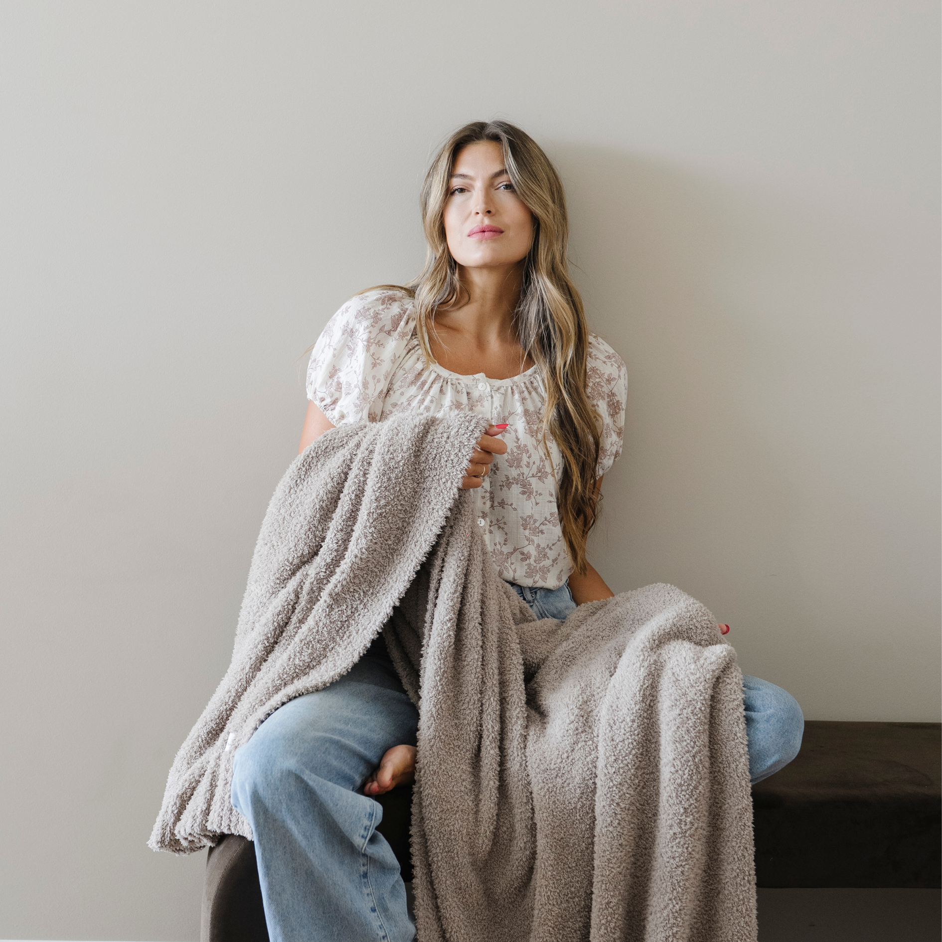 Woman wrapped in taupe bamboni extra large blanket.