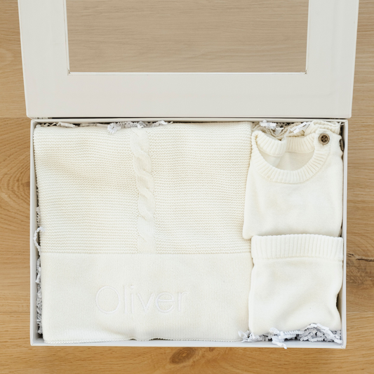 Beautiful cream baby gift box bundles with  heirloom cotton knit baby blanket and baby outfit. 