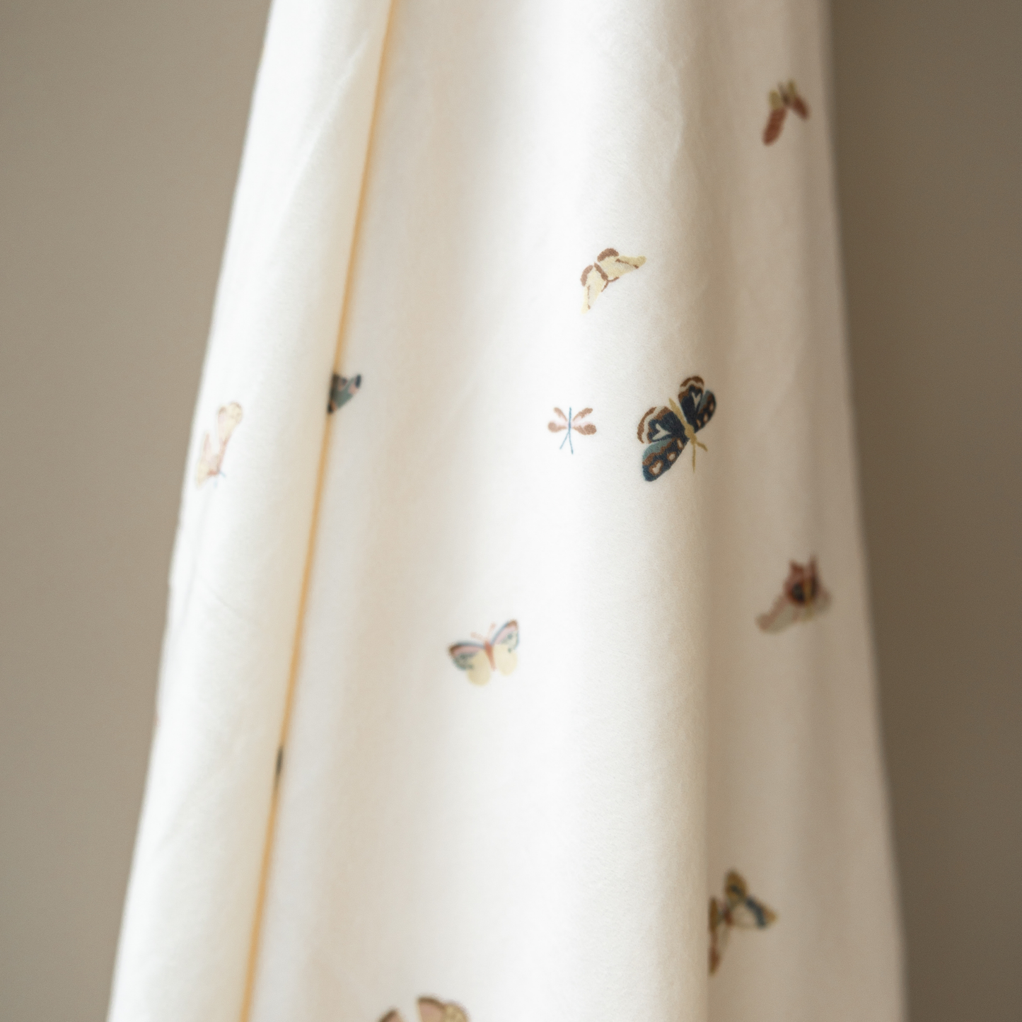 A minky stretch luxe swaddle that has a butterfly pattern on it. 