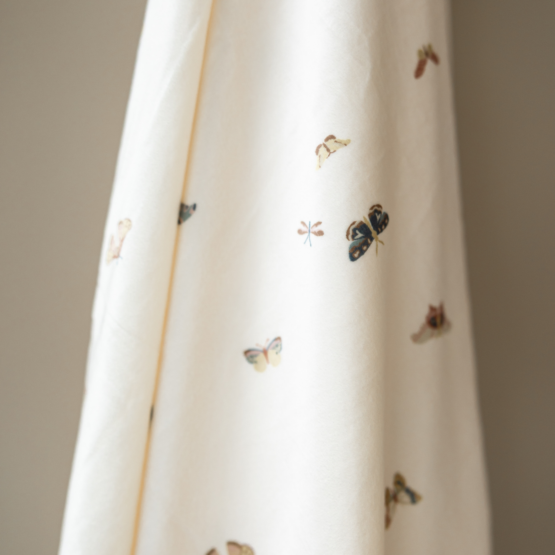 A minky stretch luxe swaddle that has a butterfly pattern on it. 