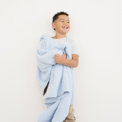 Boy snuggled with Light Blue Bamboni® Toddler Blanket.