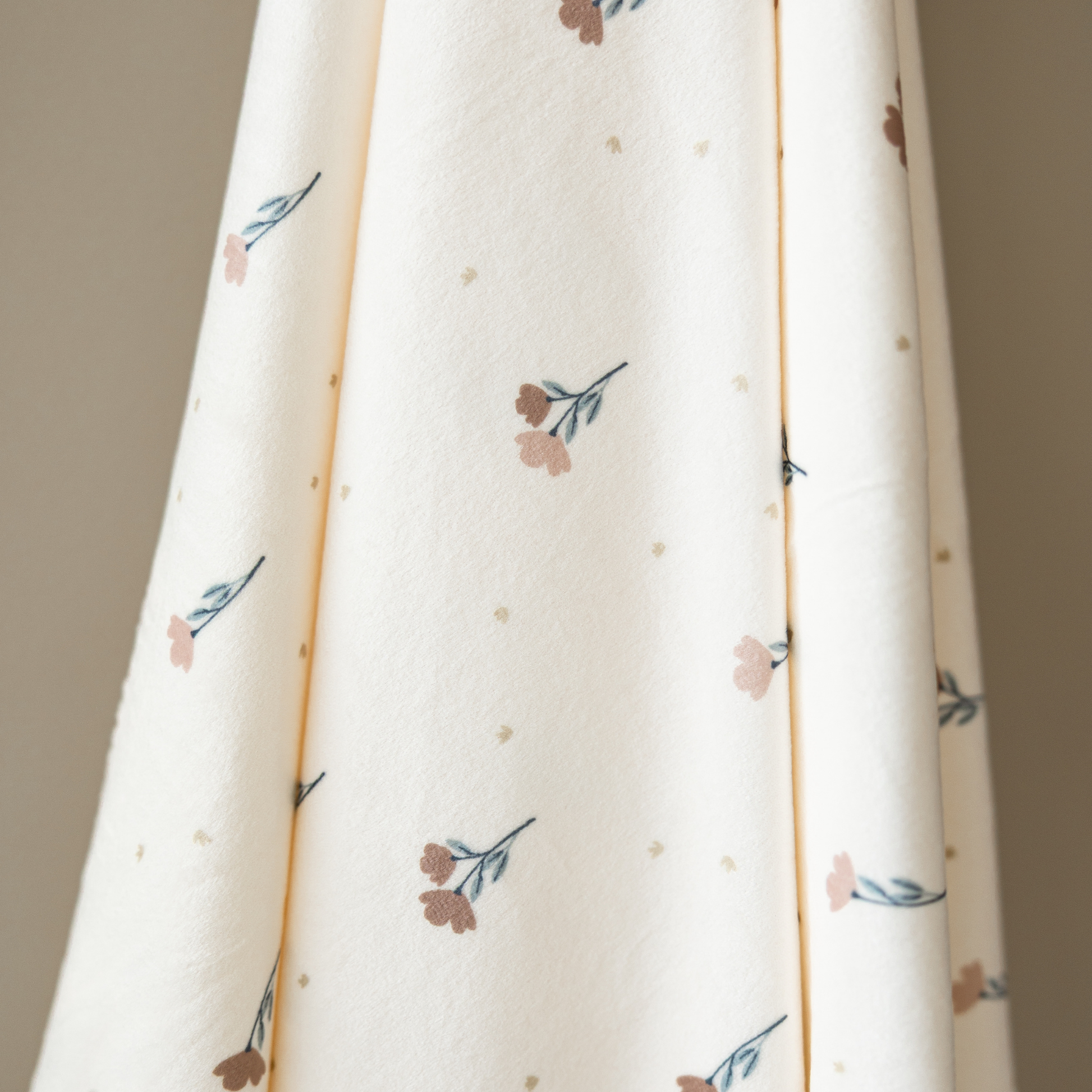 A minky stretch luxe swaddle that has a floral pattern on it. 