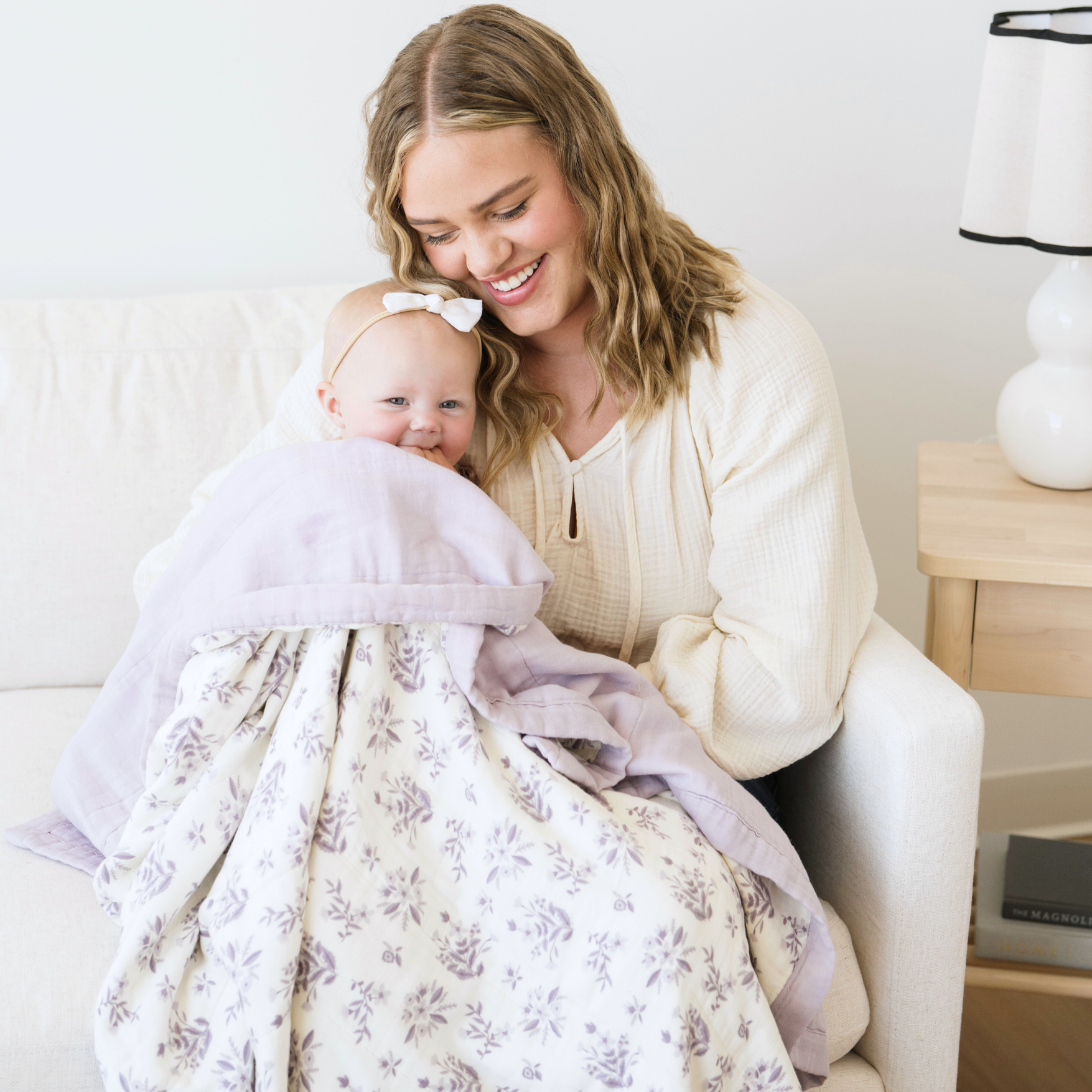 Mom snuggled with baby girl in Forget-Me-Not Bamboo Rayon Muslin 4-Layer quilt. 