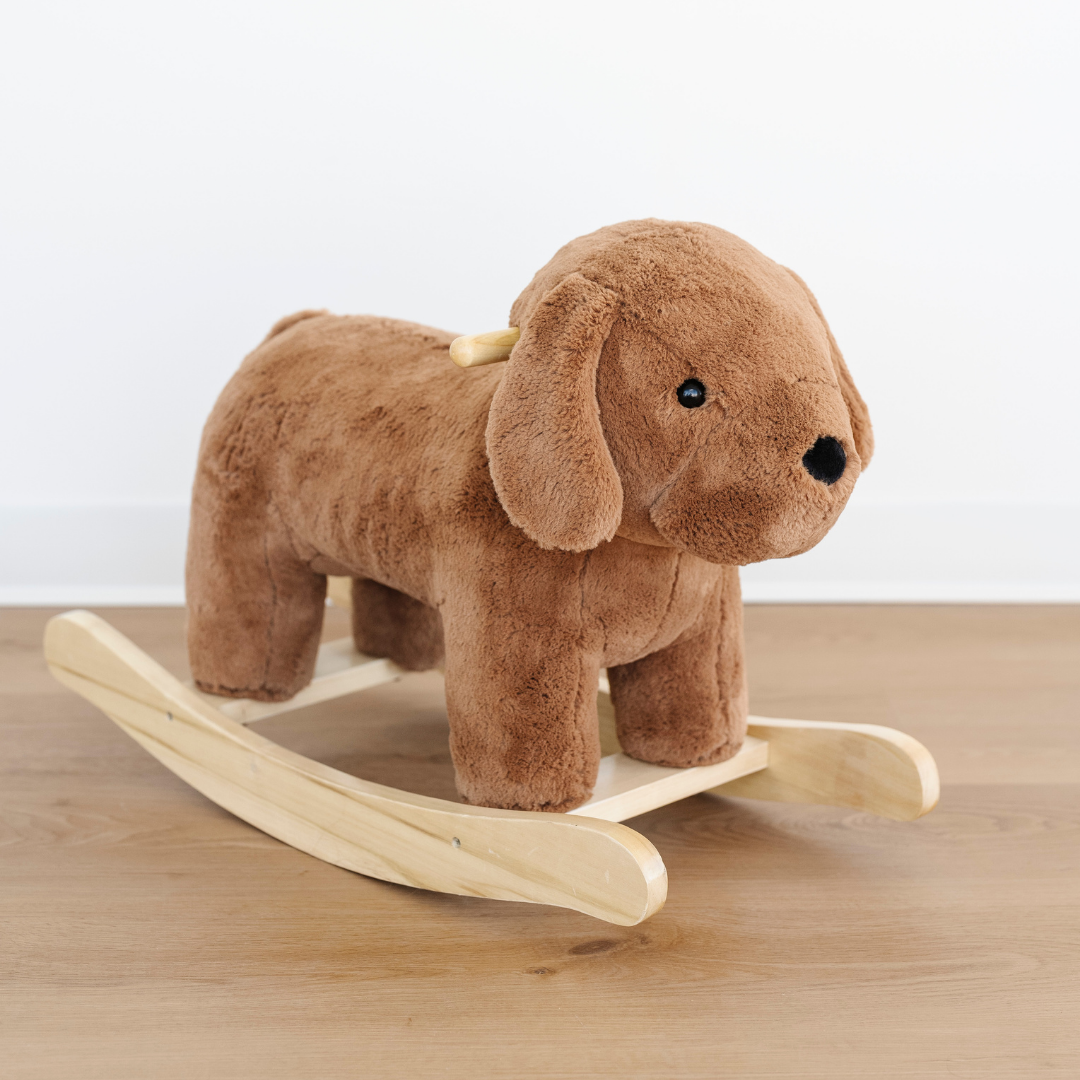A brown stuffed animal dog rocker. This kid's rocker has a soft fabric and is an adorable addition to a nursery, playroom or bedroom. This cute rocker is also a great toddler gift. 