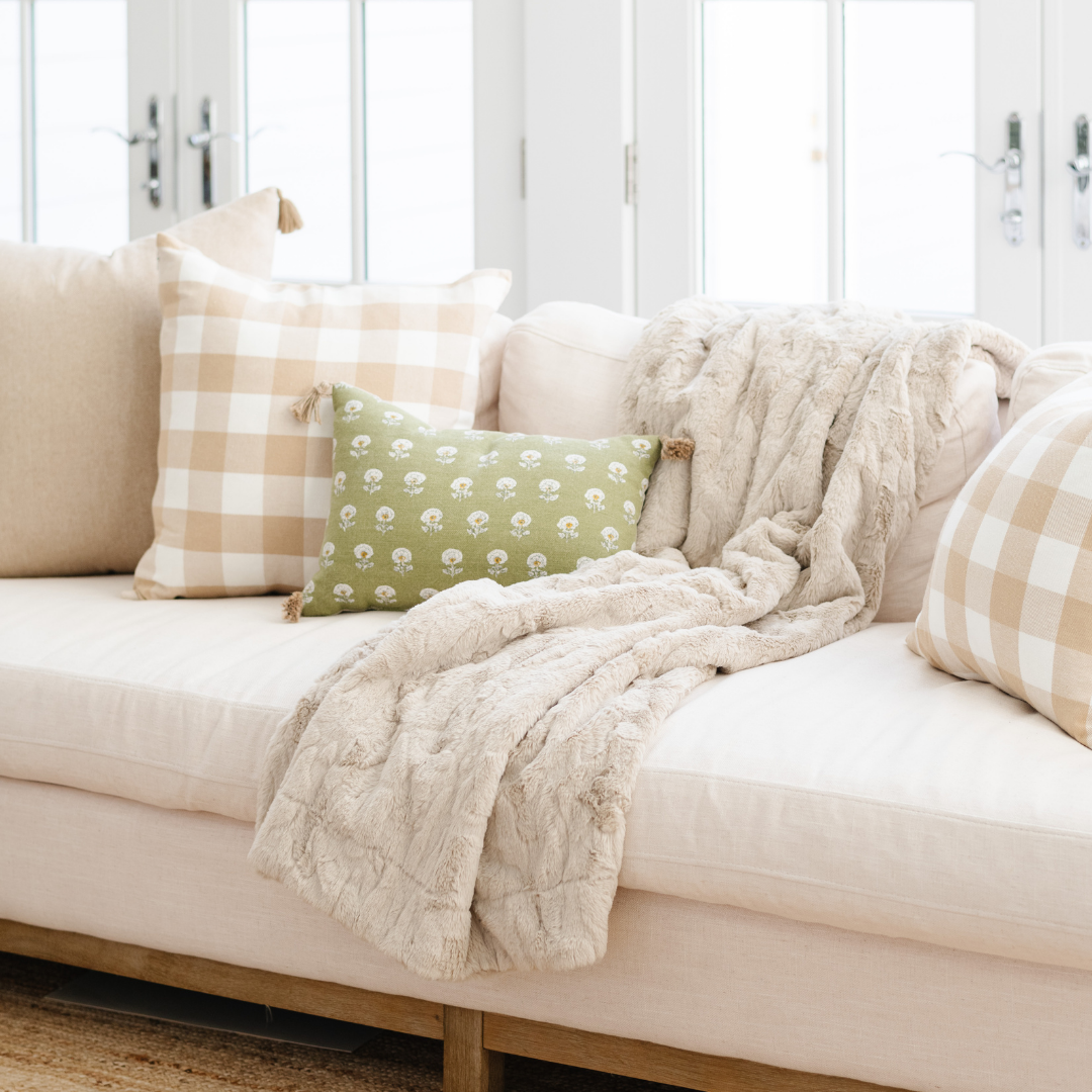 A light tan luxurious patterned faux fur throw blanket that is a Saranoni blanket is draped on a couch. This ultra-soft, plush throw blanket adds a touch of elegance and warmth to any space, perfect as a soft throw blanket or fluffy blanket for lounging. Ideal for those seeking a high-quality artificial fur blanket or luxury blanket, this versatile and stylish soft blanket enhances both comfort and decor. Shop the best blankets and throws for ultimate relaxation and cozy vibes.