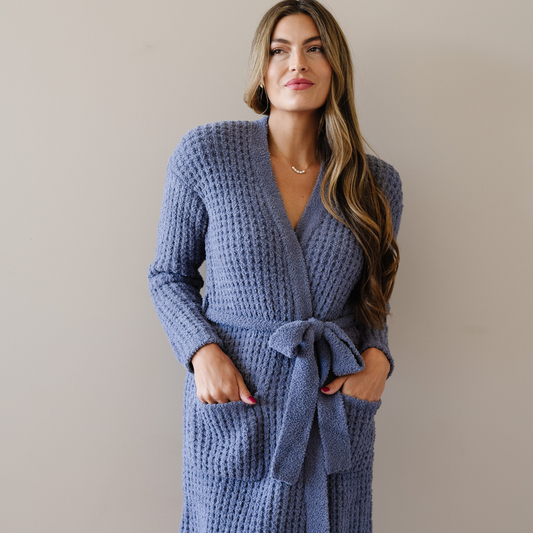 Woman standing wearing oxford blue waffle knit robe. 