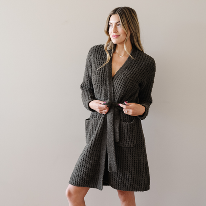 Woman wearing a deep green waffle knit robe. 