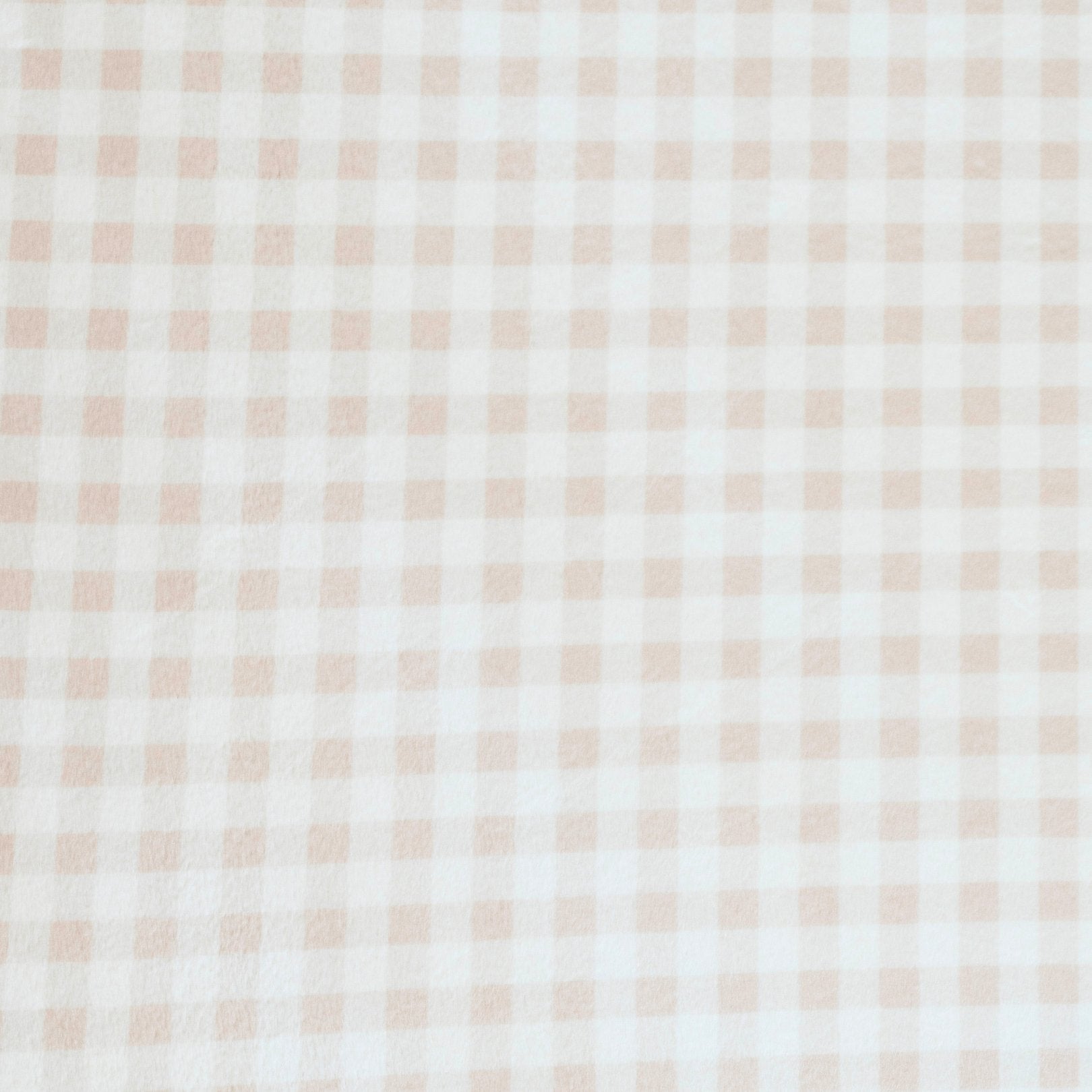 Close-up of Minky Stretch Luxe fabric in a delicate gingham pattern. Made from 94% polyester and 6% spandex, this ultra-soft, stretchy fabric is perfect for baby essentials like swaddles, changing pad covers, and crib sheets.