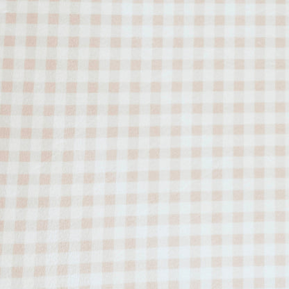 Close-up of Minky Stretch Luxe fabric in a delicate gingham pattern. Made from 94% polyester and 6% spandex, this ultra-soft, stretchy fabric is perfect for baby essentials like swaddles, changing pad covers, and crib sheets.