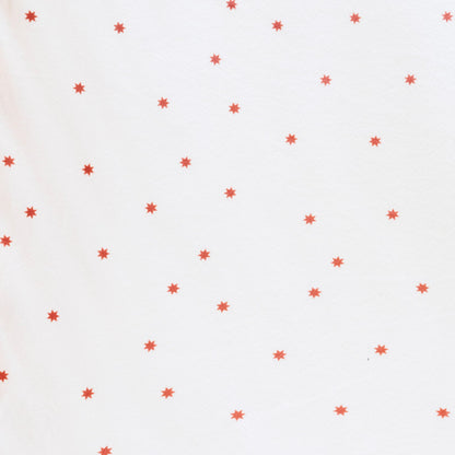 Close-up of Minky Stretch Luxe fabric in a delicate star pattern. Made from 94% polyester and 6% spandex, this ultra-soft, stretchy fabric is perfect for baby essentials like swaddles, changing pad covers, and crib sheets.