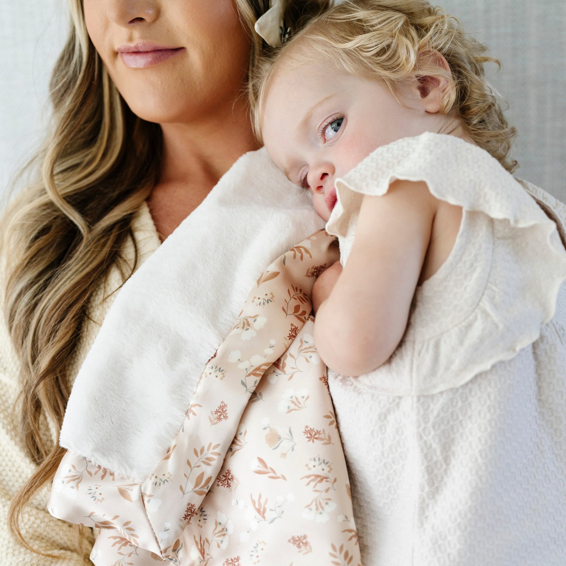 Cozy toddler blanket with a satin back, designed to provide a warm, cuddly front with a sleek, silky underside for a perfect touch of refined comfort.