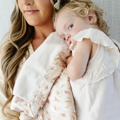 Cozy toddler blanket with a satin back, designed to provide a warm, cuddly front with a sleek, silky underside for a perfect touch of refined comfort.