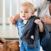 Baby boy walking with mini charcoal security blanket.