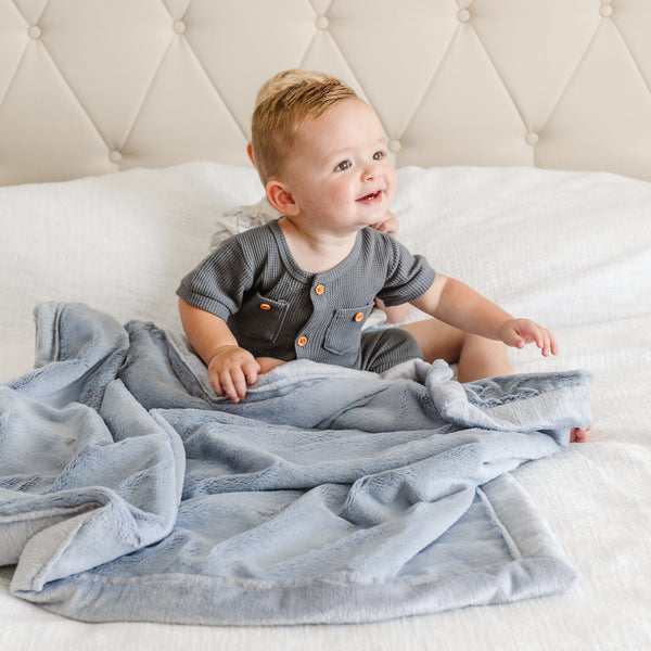 Storm Cloud@Two little boys sit together on a bed with a super soft lush baby blanket.