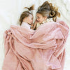 Ballet Slipper@Sisters lay on bed under dusty pink kids blanket