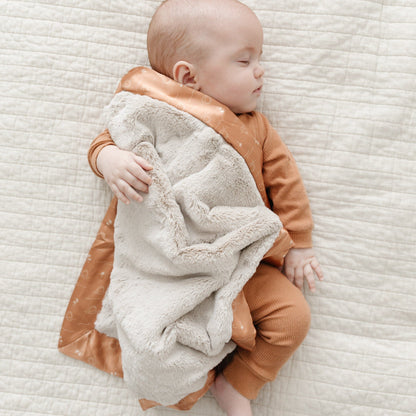 Compact mini blanket with a rich, velvety surface and a satin border, perfect for wrapping in warmth and elegance.