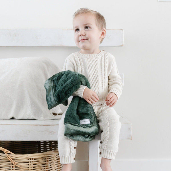 Hunter@An adorable baby boy holds his faux fur forest green baby blanket.