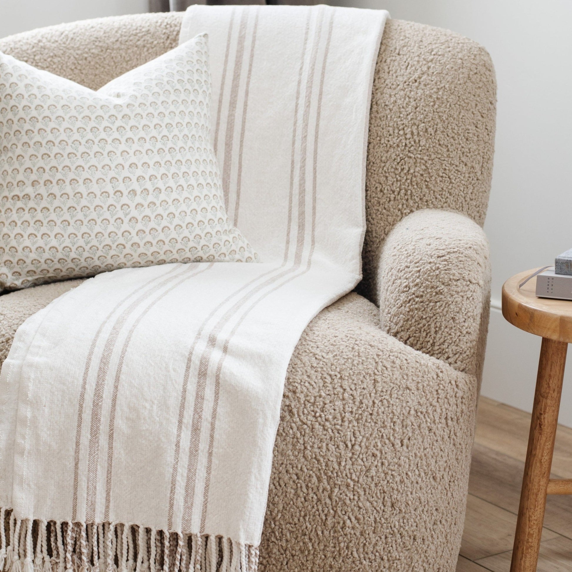 Comfy chenille fringe blanket draped over a contemporary chair - Saranoni