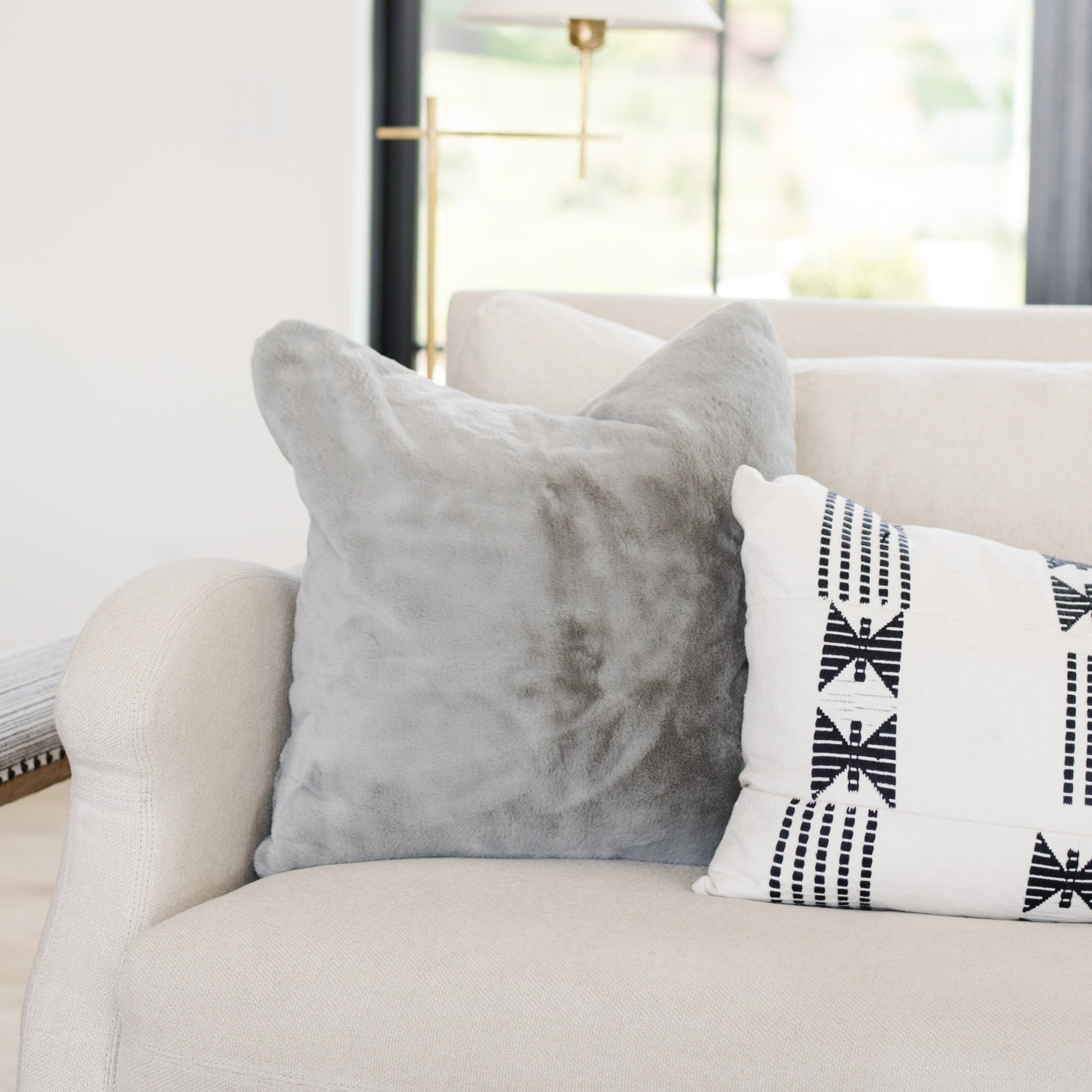 Decorative Saranoni Grand Pillow Cover on a Couch - Enhances living room aesthetics with its large, fluffy design.