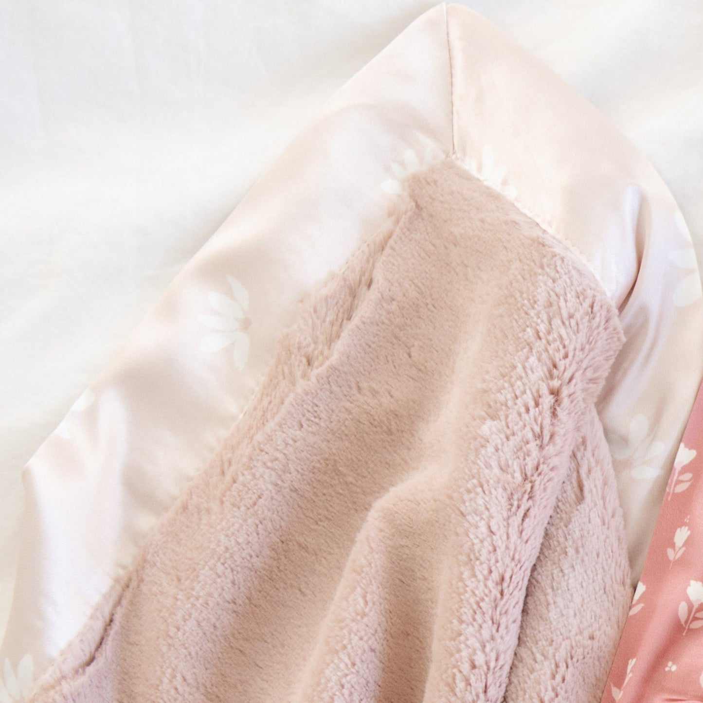 Elegant receiving blanket with a plush front and satin back, offering both warmth and a touch of silky luxury.